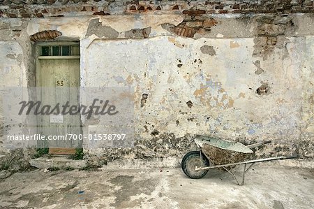 Wheelbarrow Near Plastered Wall