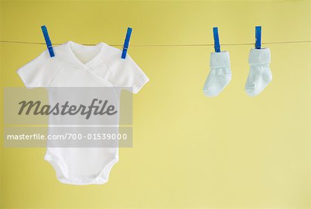 Baby's Onesie and Socks Hanging on Clothesline