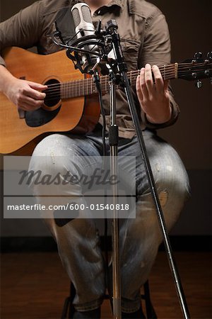 Man Playing Guitar in Recording Studio