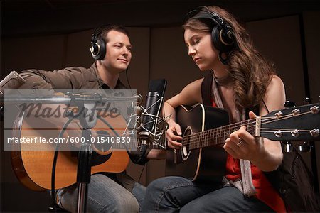 Musicians Playing Guitar in Recording Studio