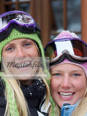 Two young blonde women in ski-wear, close-up, portrait