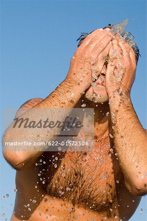 Man Slapping Water On His  Face