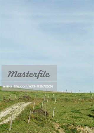 Dirt road through rural landscape