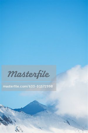 Switzerland, clouds moving over snowy mountains