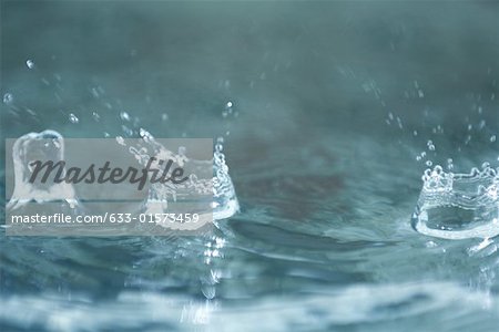 Drops of water hitting surface of water