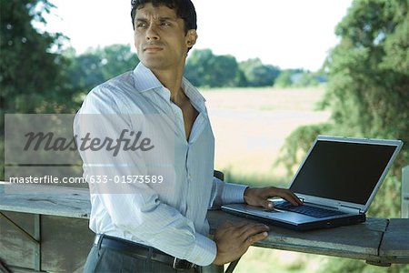 Businessman standing outdoors, with laZSop