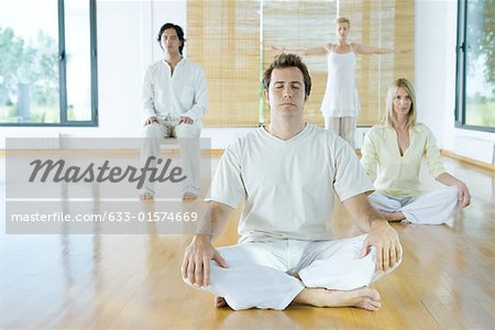 Group meditation, adults sitting in different positions