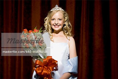 Beauty pageant winner smiling and holding roses