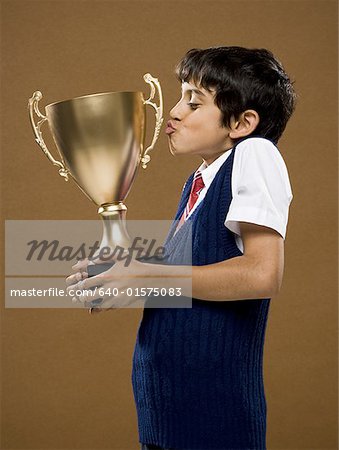 Boy kissing trophy cup