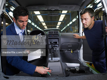 Two Men Inspecting Car