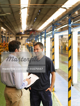 Men Talking in Automotive Plant