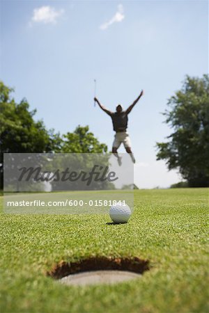 Golfer Jumping in Air