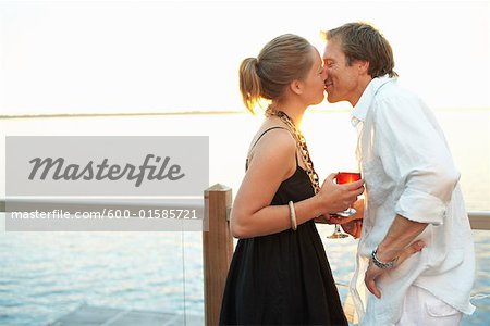 Couple Kissing by the Lake at Sunset