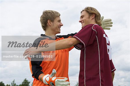 Kicker and goalkeeper embracing each other