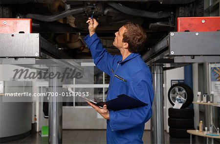 Mechanic Looking Under Vehicle