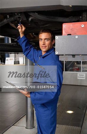 Mechanic Looking Under Vehicle