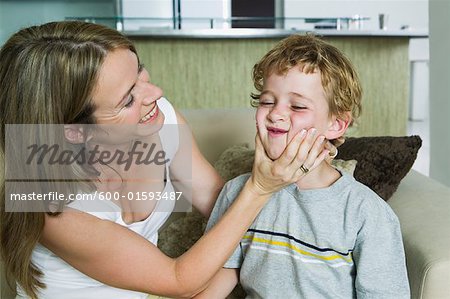 Mother Squeezing Son's Cheeks