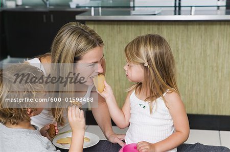 Mother and Children Eating Cookies