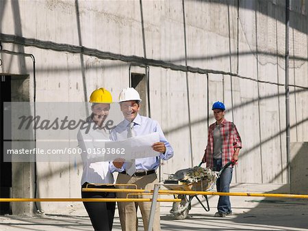 Engineers and Construction Worker on Construction Site