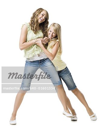 Two girls play fighting and smiling