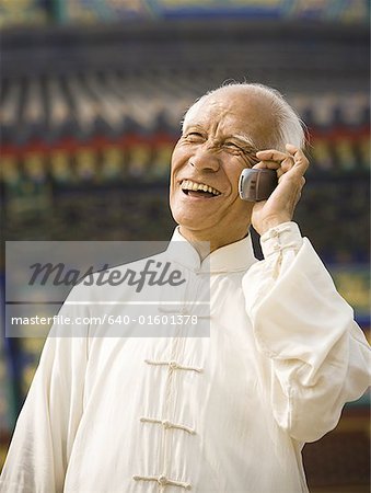 Man talking on cell phone outdoors smiling