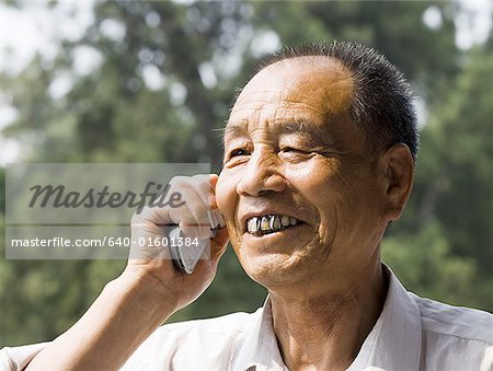 Man talking on cell phone outdoors smiling