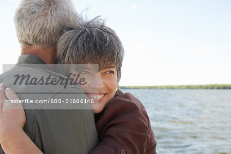 Couple Hugging by Water Couple Hugging by Water