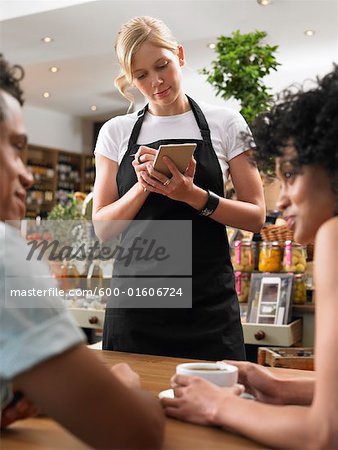 Couple and Waitress in Cafe