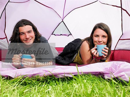 Couple with mugs in pink tent