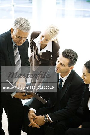 Business associates looking at report together