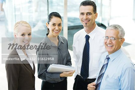 Four business associates, smiling at camera, portrait