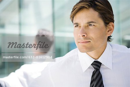 Businessman, looking out of frame, head and shoulders, portrait