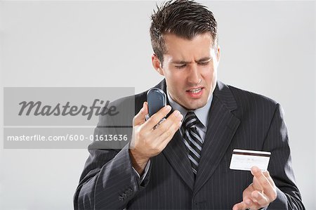 Man with Cellular Phone and Credit Card