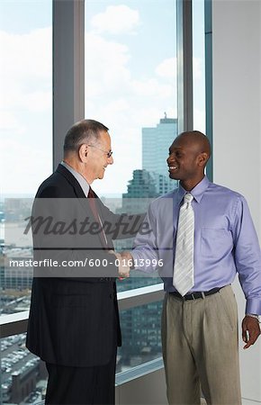 Businessmen in Office Shaking Hands