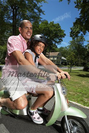 Father and Daughter Riding Scooter