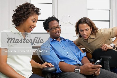 Coworkers looking at cell phone