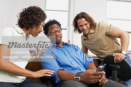 Coworkers looking at cell phone