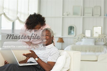 Couple using laptop together