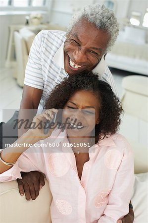 Couple using cell phone together