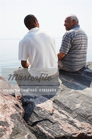 Father and Son on Rocks by Water