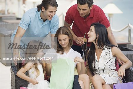 Two couples and child with shopping bags