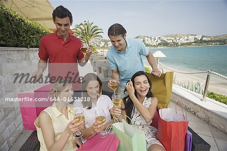 Groupe d'amis avec des sacs à provisions et le vin
