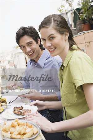 Couple at a table with Greek food