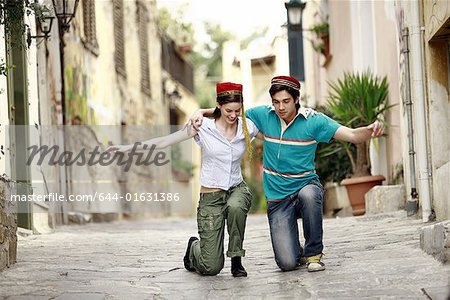 Couple with Greek costume hats dancing