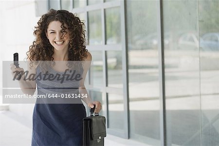 Happy businesswoman with cell phone