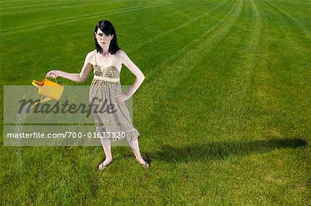 Woman Watering the Lawn