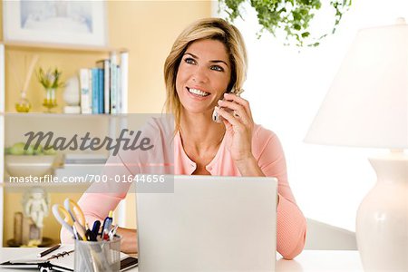 Woman with Laptop Computer and Cellular Phone
