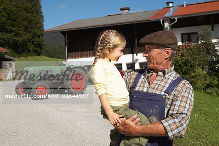 Farmer Holding Girl