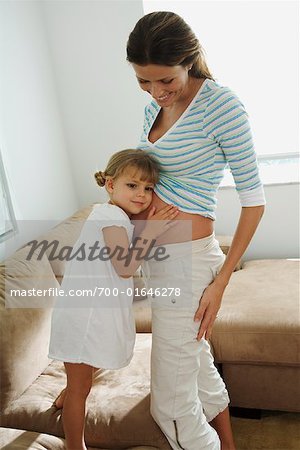 Girl Listening to Pregnant Mother's Belly