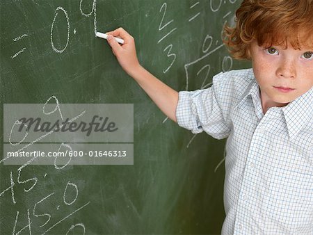 Portrait of Boy Writing on Blackboard